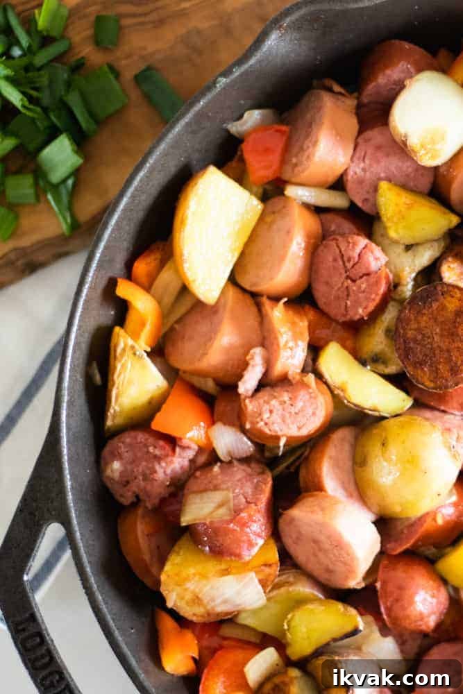 polish sausage and new potatoes in a cast iron skillet