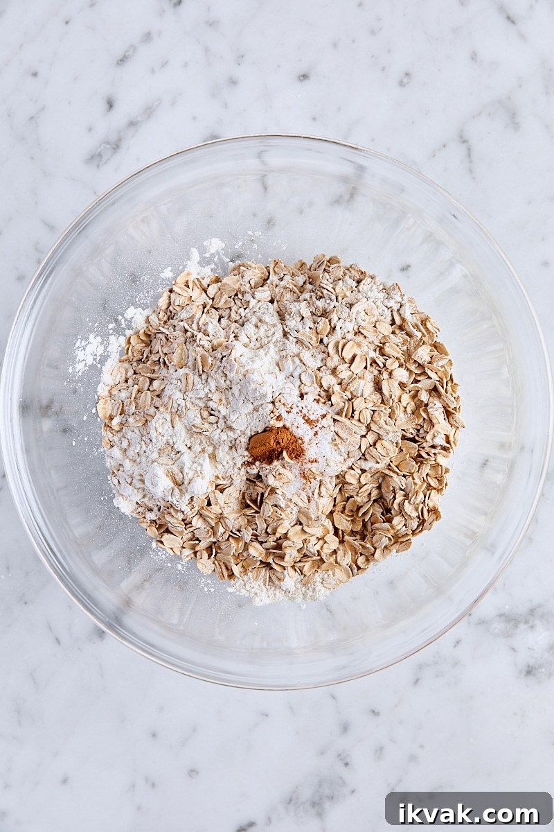 Chewy Raspberry Crumble Bars with Oat Crust 4 All-purpose flour, rolled oats, baking soda, salt, and cinnamon in glass bowl
