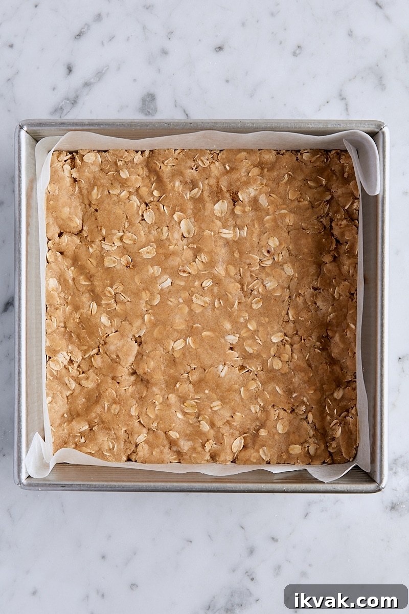 Chewy Raspberry Crumble Bars with Oat Crust 10 Crust mixture pressed into parchment-lined square baking pan