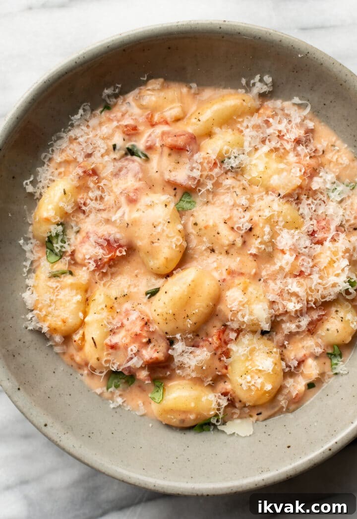 Creamy Tomato Gnocchi Recipe: Quick Weeknight Comfort Meal 2 a bowl of creamy tomato gnocchi with grated parmesan