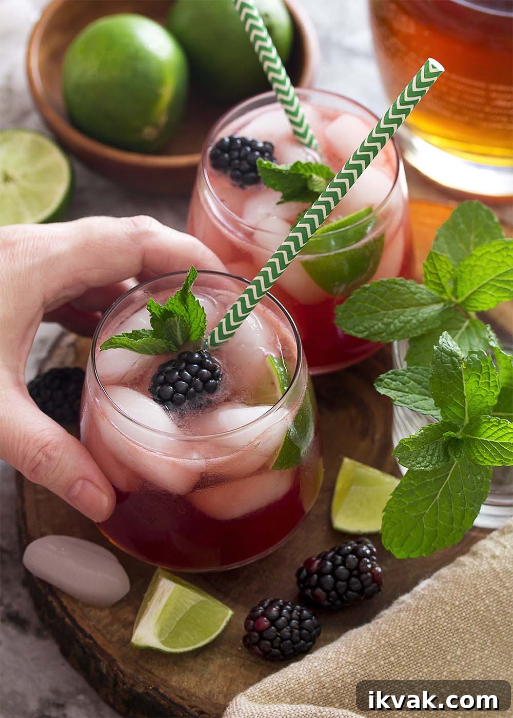 Blackberry Mojito Recipe: A Refreshing Summer Cocktail Guide 5 Top view of a hand reaching for a blackberry mojito.