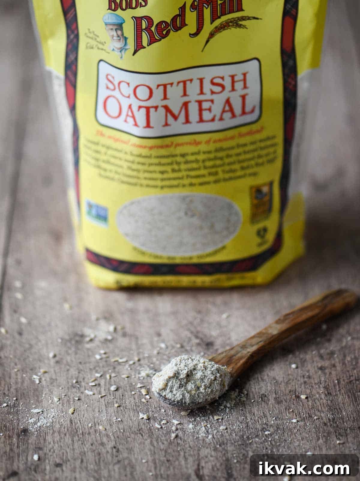 Creamy Scottish Oatmeal with Dates and Honey 3 Raw Scottish oats on a wooden spoon, with a bag of Scottish oats in the background.