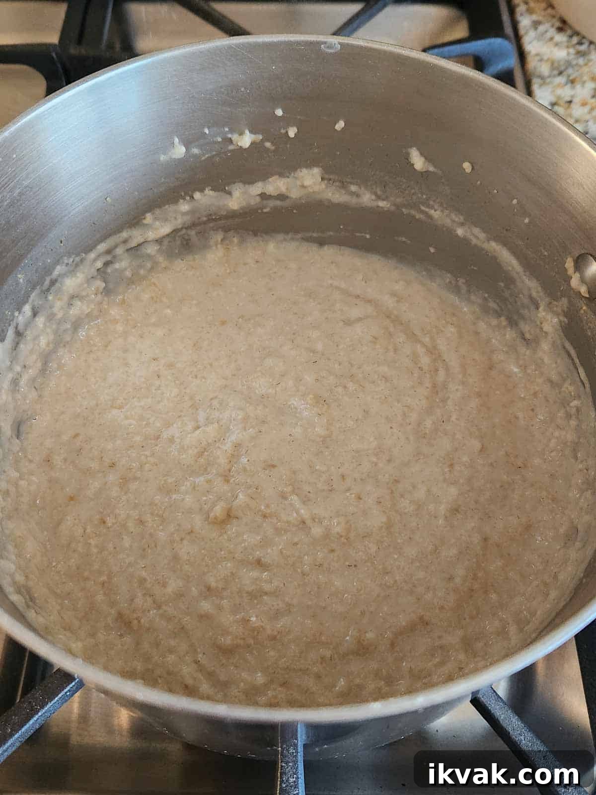 Creamy Scottish Oatmeal with Dates and Honey 6 Cooked creamy oatmeal in a pot on the stove.