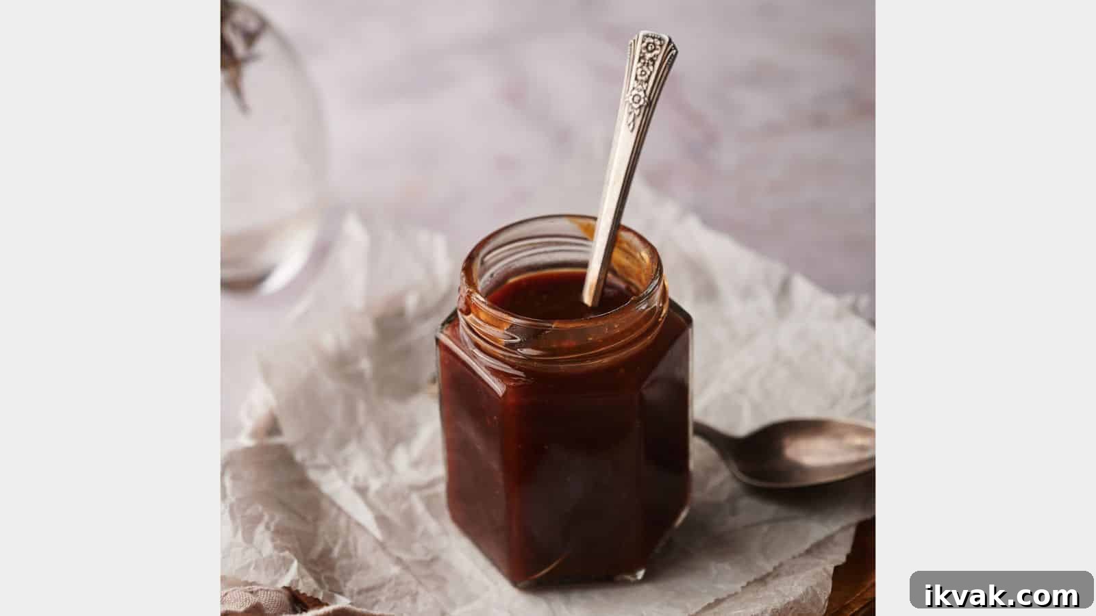 25 Creative Ways to Use Dip Recipes Beyond the Bowl 12 Homemade BBQ sauce in a jar with two spoons by the side.