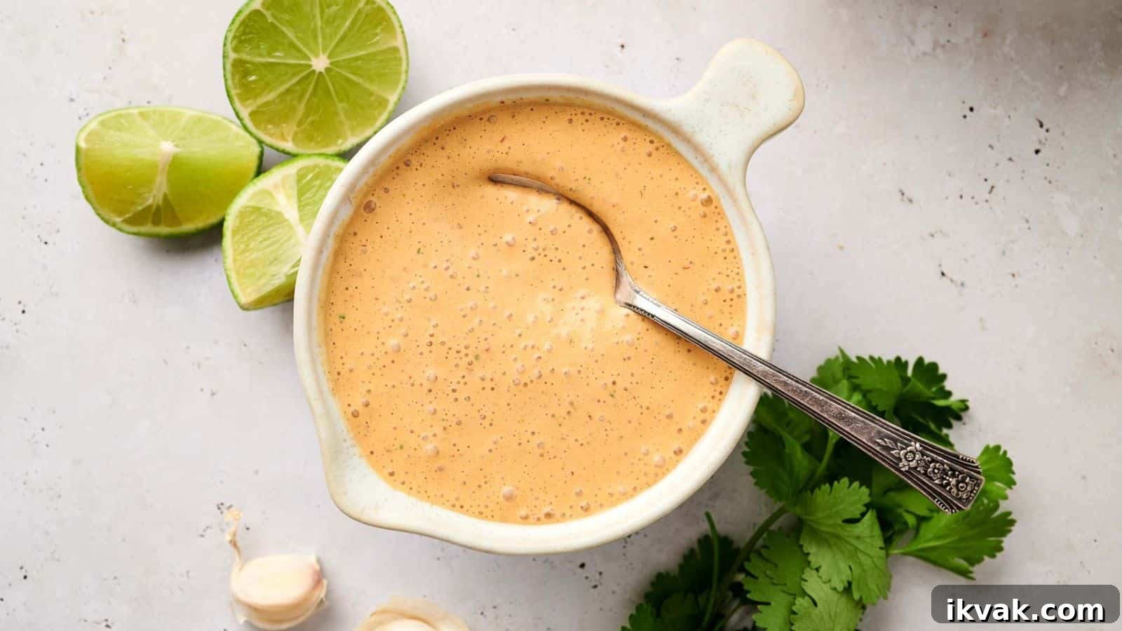 25 Creative Ways to Use Dip Recipes Beyond the Bowl 13 Creamy chipotle sauce with lime and herbs on a bright background.