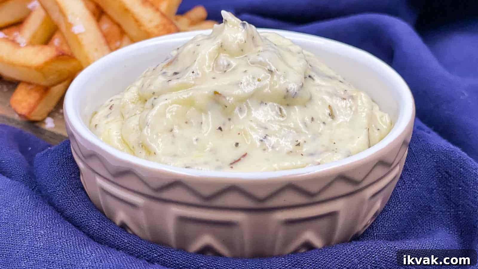 25 Creative Ways to Use Dip Recipes Beyond the Bowl 24 Garlic dip in a serving bowl with fries by it.