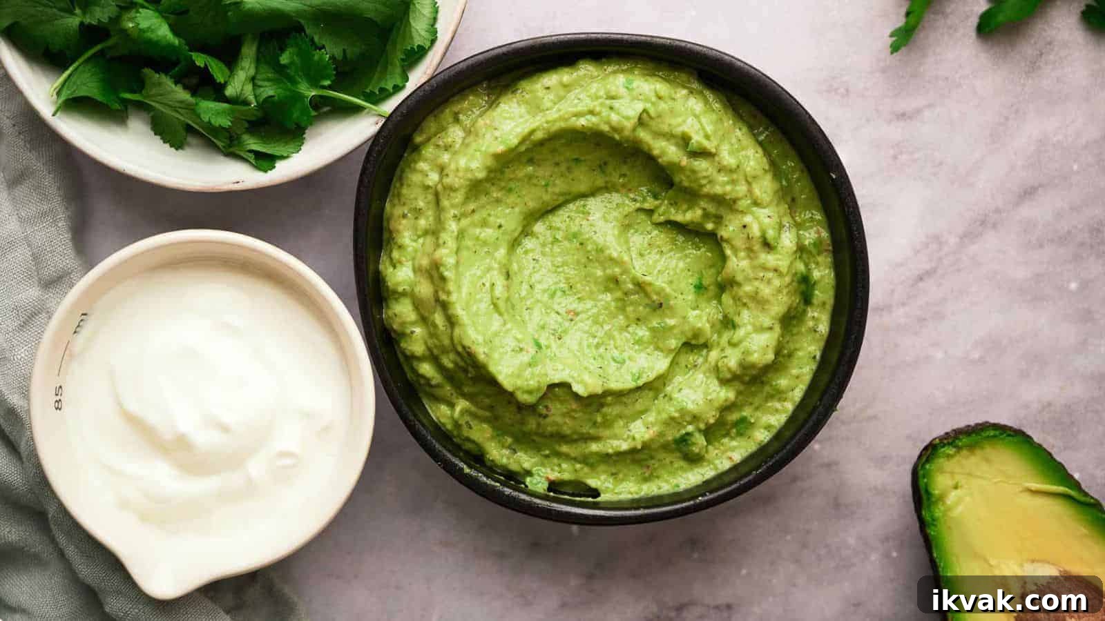 25 Creative Ways to Use Dip Recipes Beyond the Bowl 8 Avocado sauce in a bowl with it's ingredients surrounding it.