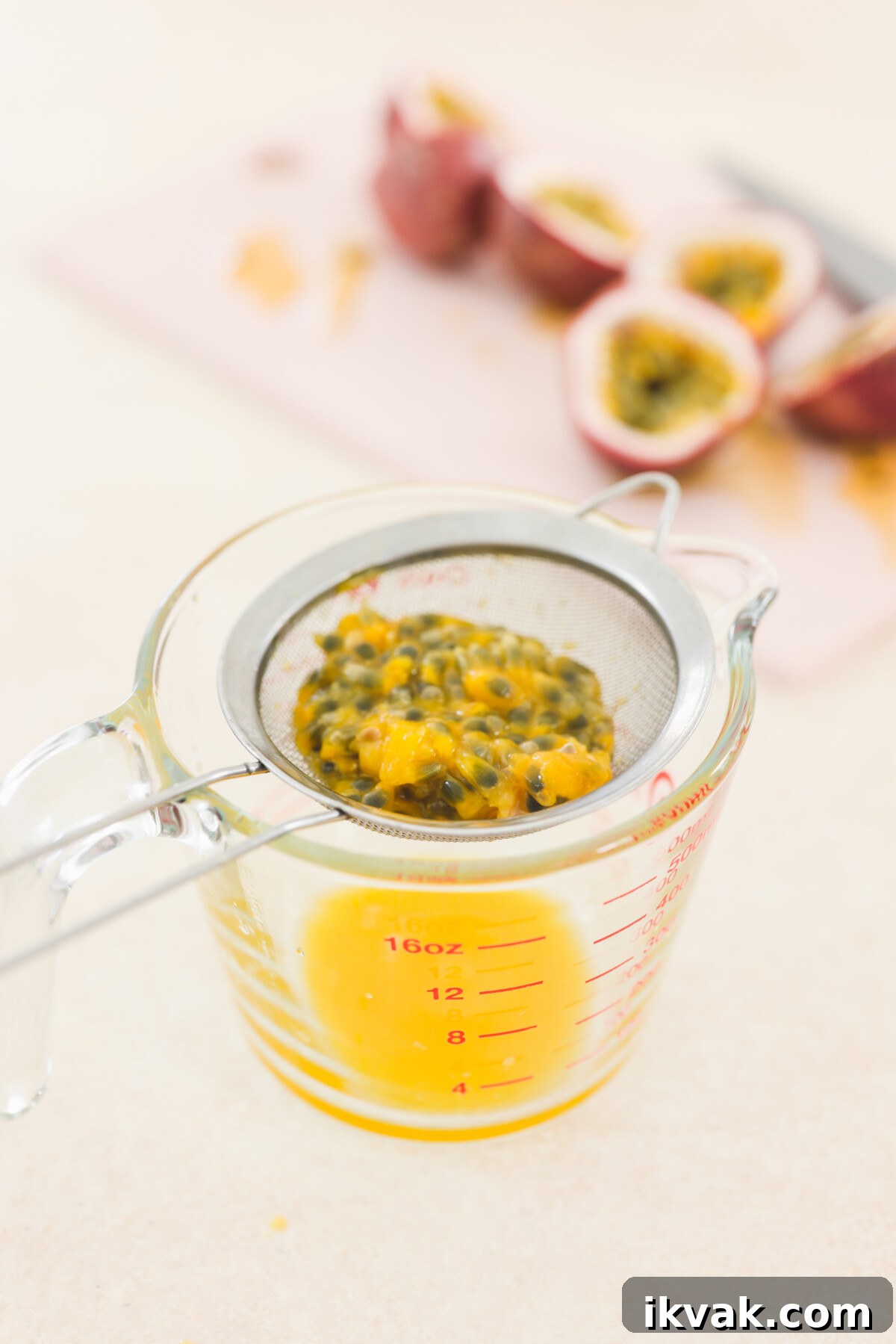 Silky Vegan Passion Fruit Posset Recipe 6 straining fruit through a sieve