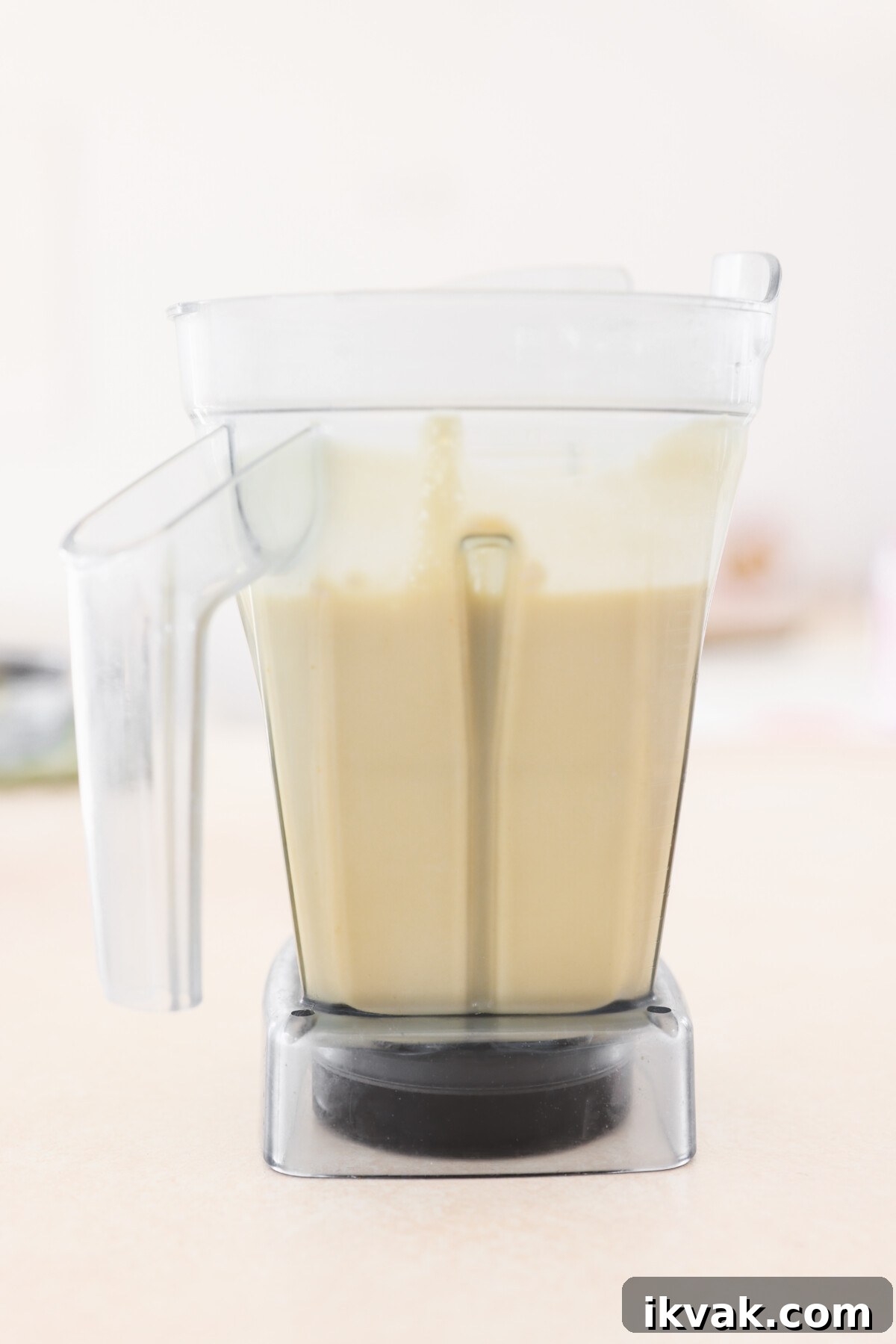 Silky Vegan Passion Fruit Posset Recipe 8 a blender filled with passion fruit posset filling