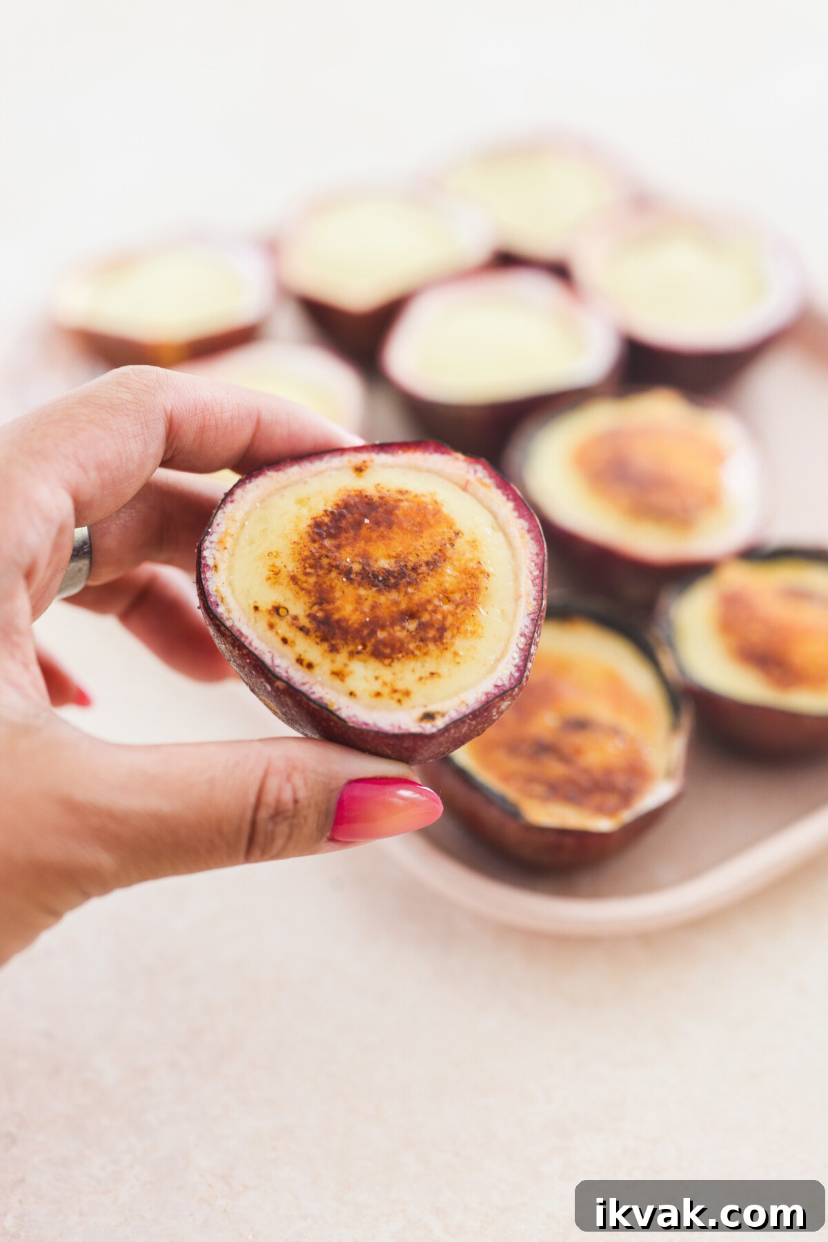 Silky Vegan Passion Fruit Posset Recipe 10 a hand holding a passion fruit posset