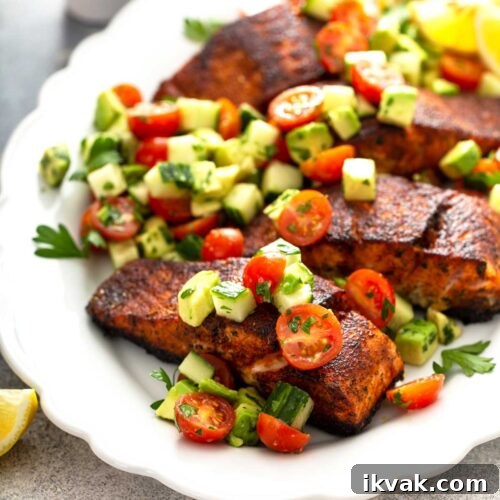 Blackened Salmon Recipe: Quick Cajun-Style Pan-Seared Fillets 14 Blackened salmon recipe with chopped salad of tomatoes, avocado and cucumbers on a white platter