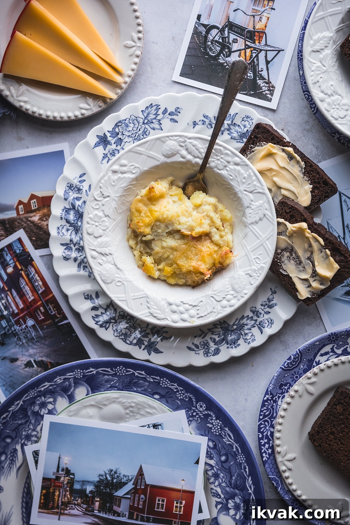 Plokkfiskur: Classic Icelandic Potato and Fish Stew 3 classic plokkfiskur in white and blue bowl surrounded by icelandic rye bread and images of iceland.