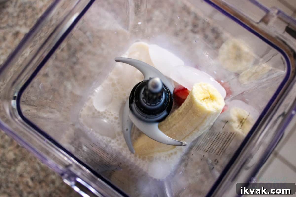 Creamy Strawberry Matcha Smoothie Recipe 4 Overhead view of blender with ingredients in it.